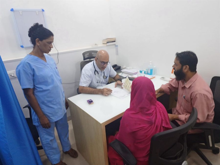 Doctor consulting a family at a check-up camp desk