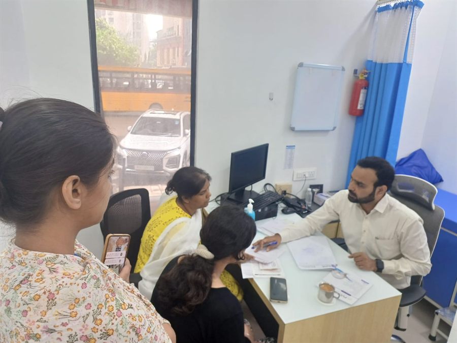 Visitors registering with staff at a camp desk