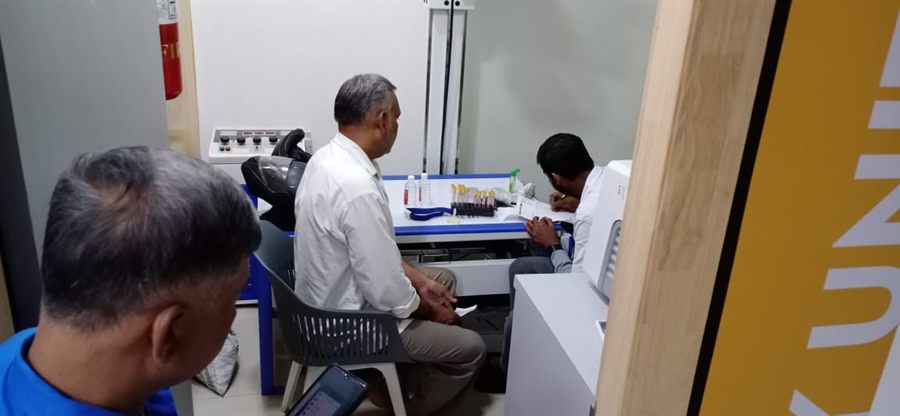 Staff assisting a visitor at a desk during a camp