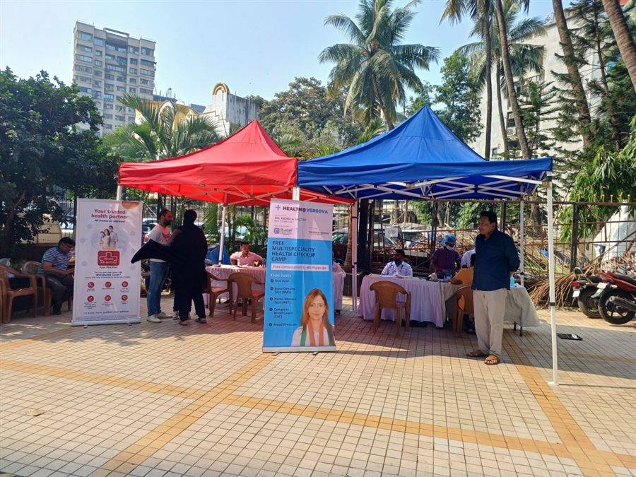Outdoor health check-up camp with Bluebell Hospital gazebos and banners
