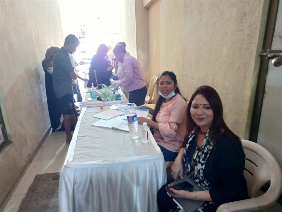 Two staff members at a camp registration table