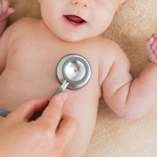 Paediatrician examining an infant with a stethoscope