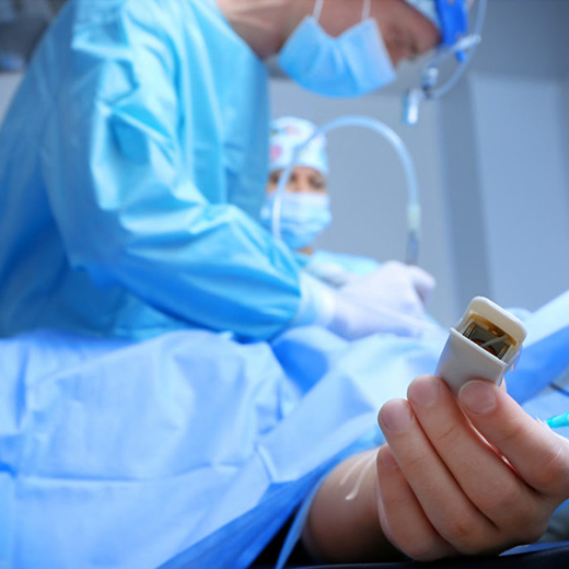 Intensive care team attending to a patient under monitoring