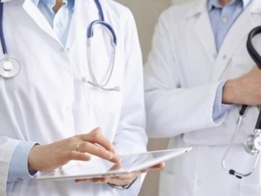 Doctors reviewing a patient chart at Bluebell Hospital